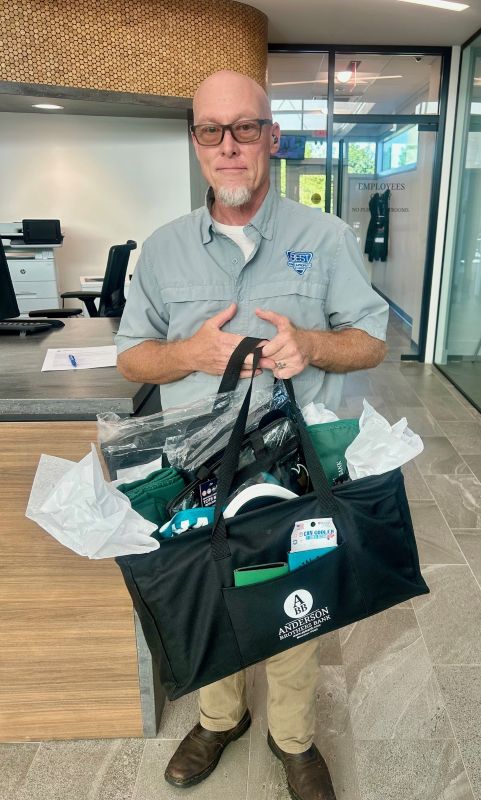 John, the Carolina Forest customer appreciation day raffle winner, is holding his prize!