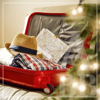 Red suitcase packed for holiday travel