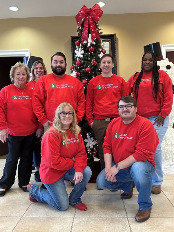 Longs group in front of Christmas tree