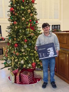 Mullins Main sweepstakes winner Devin holding espresso maker