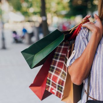 Consumer holding shopping bags