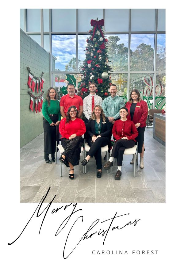Carolina Forest branch employees in front of Christmas tree