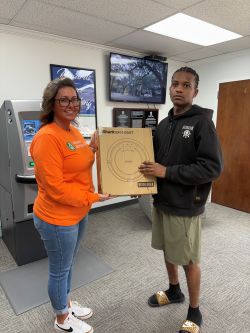 Employee presenting sweepstakes winner with prize