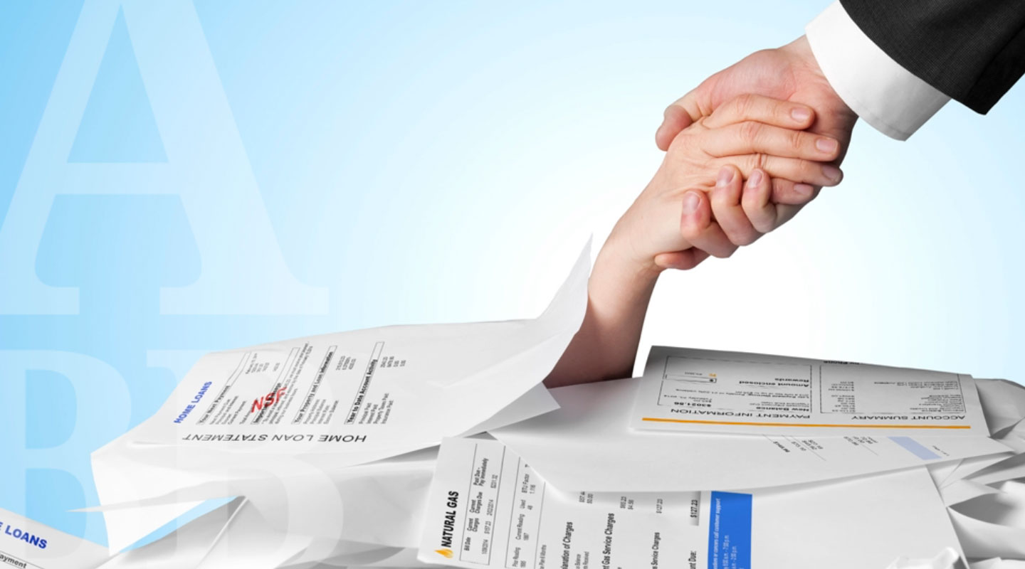 hand reaching for help from a stack of bills