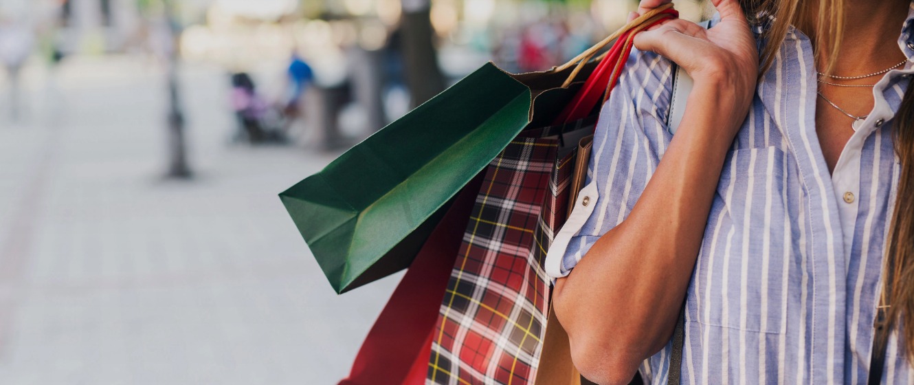 Consumer holding shopping bags